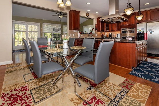 dining space featuring ceiling fan, light hardwood / wood-style floors, and sink