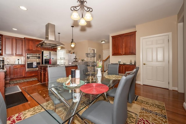 dining area featuring dark hardwood / wood-style flooring and a notable chandelier