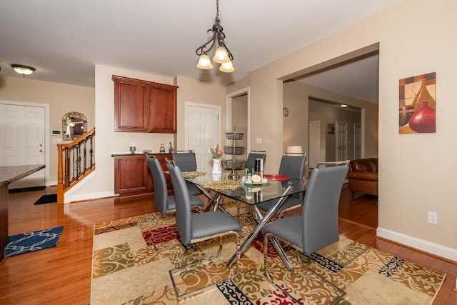 dining room featuring hardwood / wood-style floors and an inviting chandelier