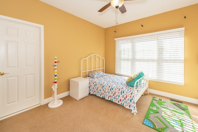 carpeted bedroom with ceiling fan