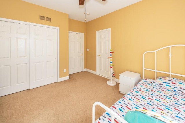 bedroom featuring ceiling fan and light carpet