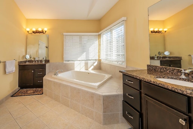 bathroom featuring vanity, tile patterned floors, and tiled tub