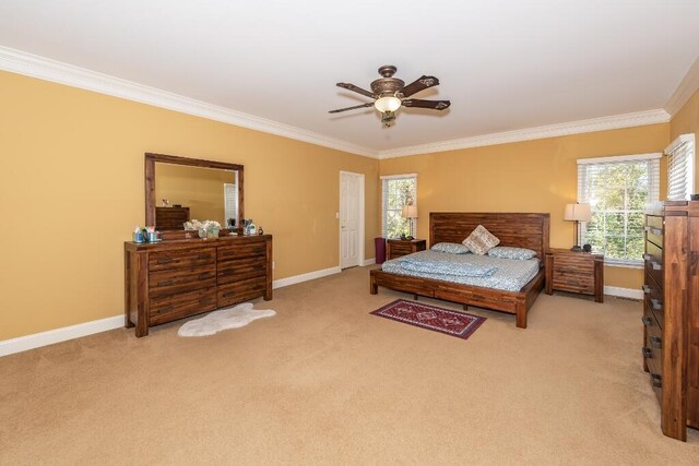 carpeted bedroom with ceiling fan and crown molding