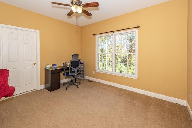 carpeted office with ceiling fan