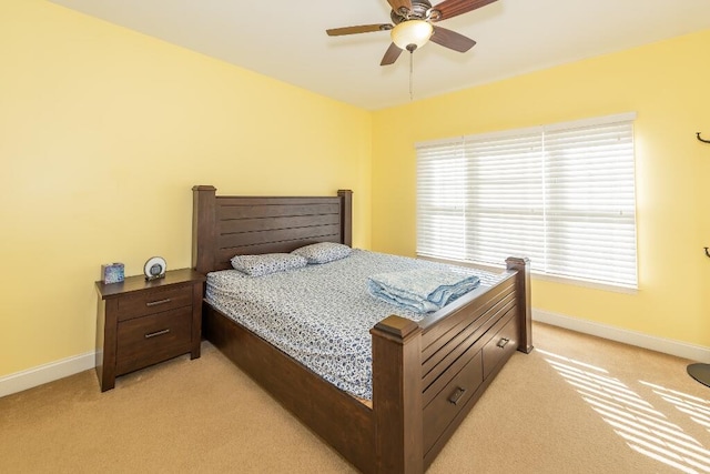 bedroom featuring light colored carpet and ceiling fan