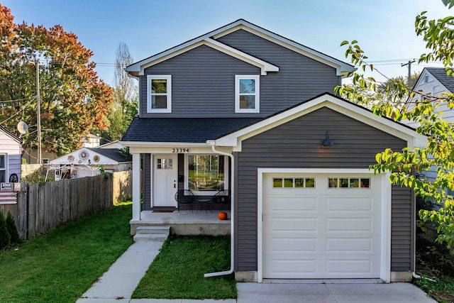 view of front of house featuring a front lawn, a porch, and a garage