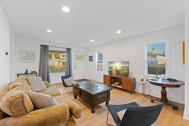 living room with plenty of natural light and light hardwood / wood-style floors