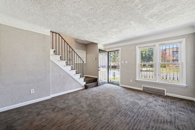 19789-19791 Meyers Rd, Detroit, MI 48235 - entryway with a textured wall, a textured ceiling, baseboards, stairway, and carpet