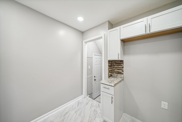 19789-19791 Meyers Rd, Detroit, MI 48235 - kitchen with light marble finish floors, white cabinets, decorative backsplash, baseboards, and light stone counters