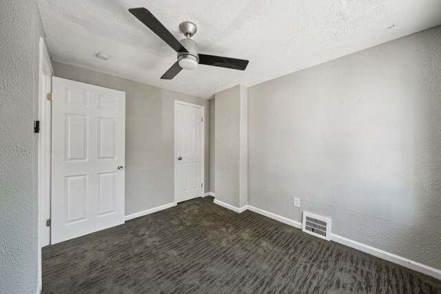 19789-19791 Meyers Rd, Detroit, MI 48235 - unfurnished bedroom featuring a textured wall, dark colored carpet, baseboards, a textured ceiling, and a ceiling fan