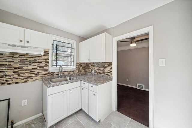 19789-19791 Meyers Rd, Detroit, MI 48235 - kitchen with under cabinet range hood, a sink, tasteful backsplash, and white cabinets