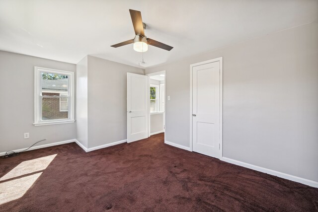 19789-19791 Meyers Rd, Detroit, MI 48235 - unfurnished bedroom with dark colored carpet, baseboards, and ceiling fan