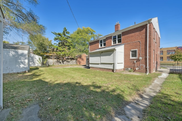 19789-19791 Meyers Rd, Detroit, MI 48235 - rear view of house with brick siding and a chimney