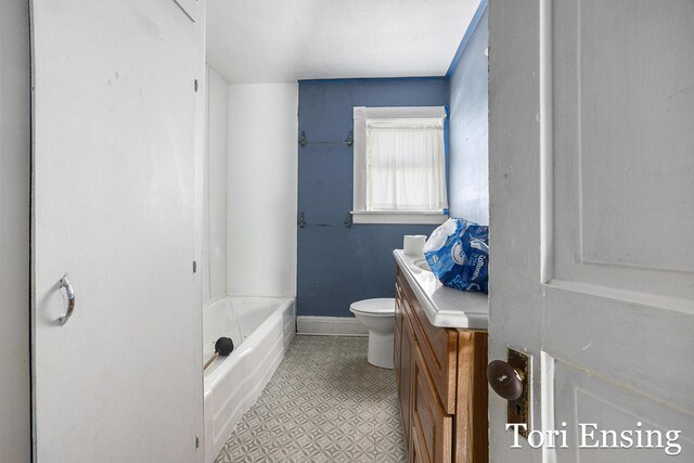 421 Lewis St, Belding, MI 48809 - bathroom featuring toilet, vanity, and baseboards
