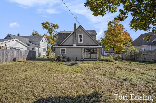 421 Lewis St, Belding, MI 48809 - rear view of house with a chimney and a shingled roof