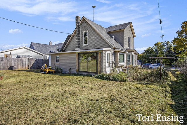 421 Lewis St, Belding, MI 48809 - rear view of property featuring a chimney