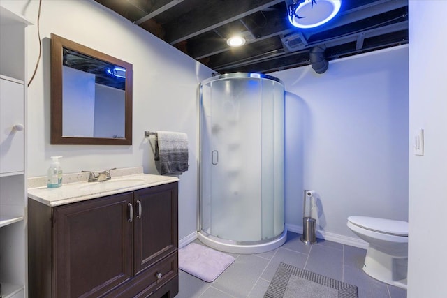 bathroom with vanity, tile patterned flooring, toilet, and walk in shower