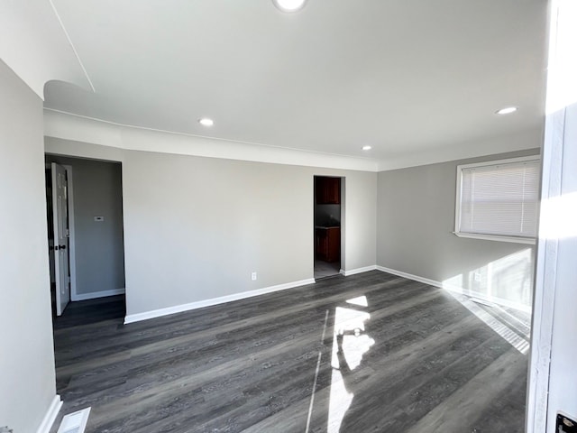 spare room with dark hardwood / wood-style flooring