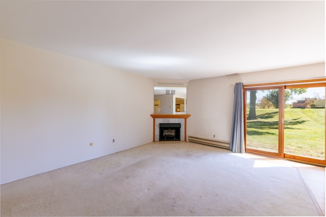 unfurnished living room featuring a tile fireplace, carpet, and a baseboard heating unit