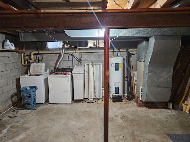 basement with heating unit, water heater, and washer and dryer