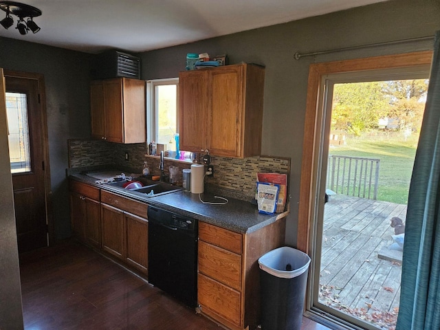 kitchen featuring dishwasher, decorative backsplash, plenty of natural light, and sink