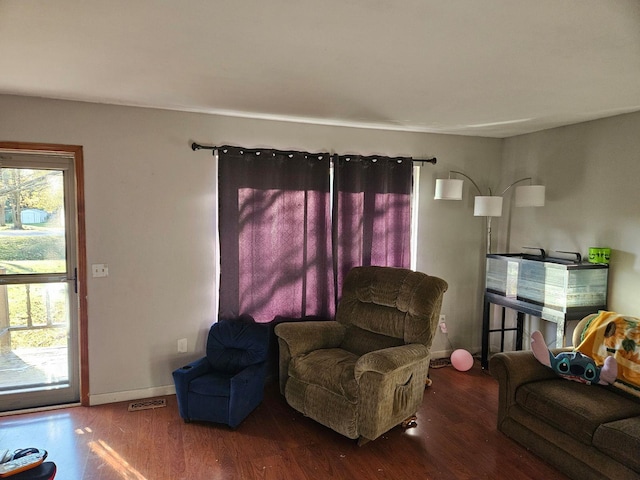 living room with dark hardwood / wood-style flooring