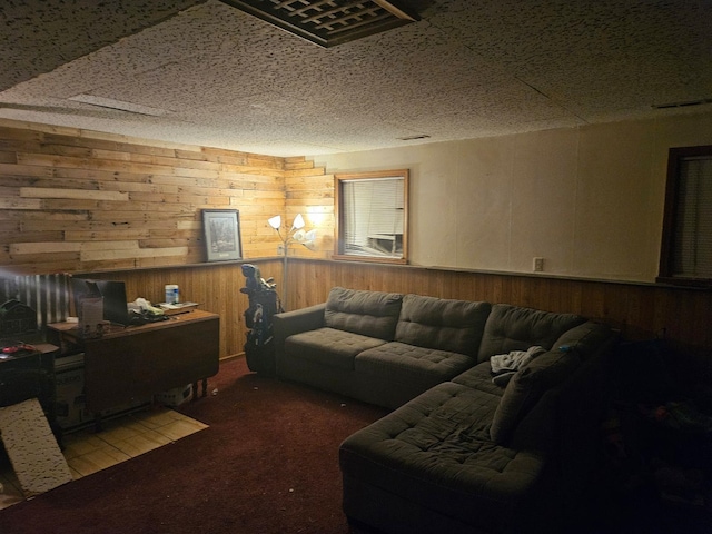 carpeted living room featuring wood walls