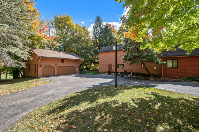 view of home's exterior with a lawn and a garage