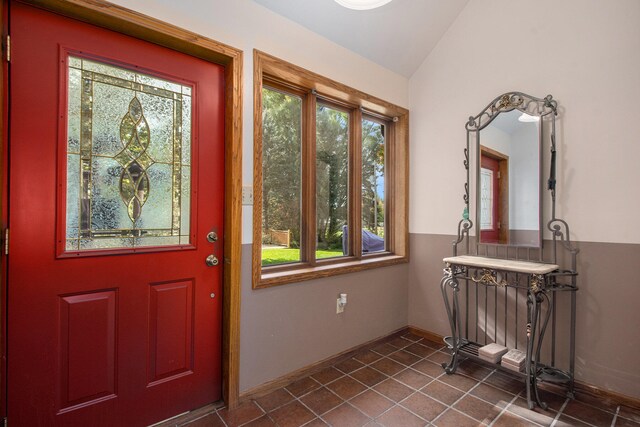 tiled foyer with vaulted ceiling