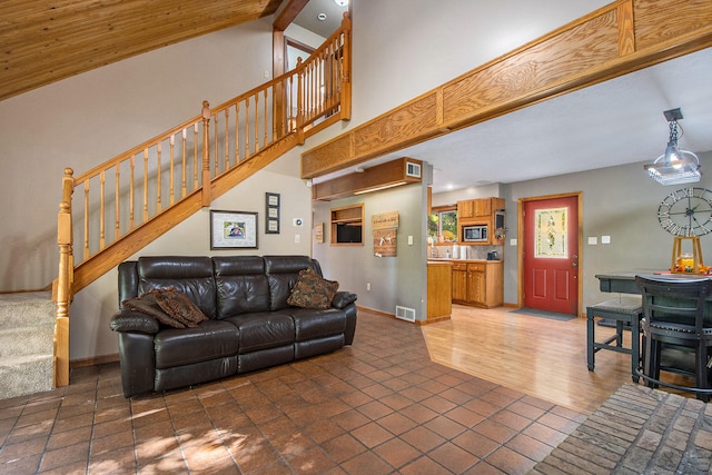 living room with beamed ceiling, dark hardwood / wood-style flooring, and high vaulted ceiling