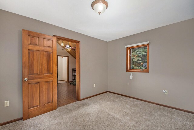 carpeted spare room with ceiling fan