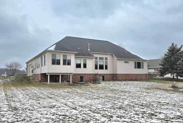 snow covered property with cooling unit