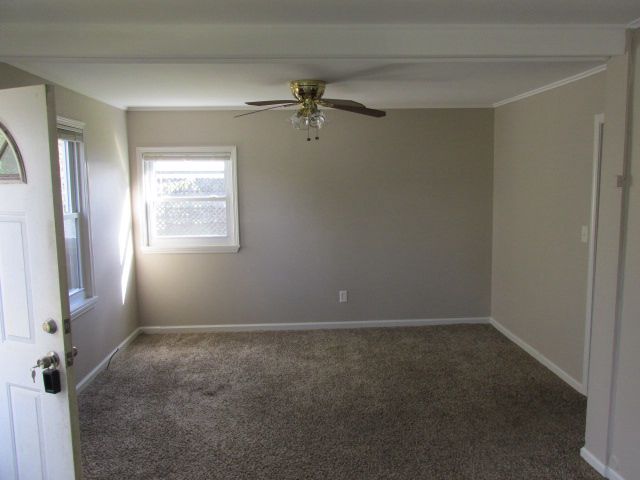 carpeted empty room with ceiling fan