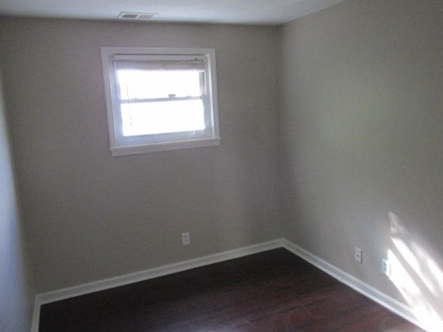 spare room featuring dark hardwood / wood-style floors