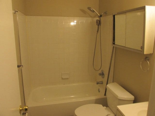 full bathroom featuring vanity, toilet, and tiled shower / bath