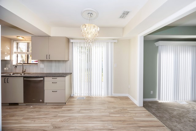 kitchen featuring sink, stainless steel dishwasher, tasteful backsplash, decorative light fixtures, and light hardwood / wood-style floors