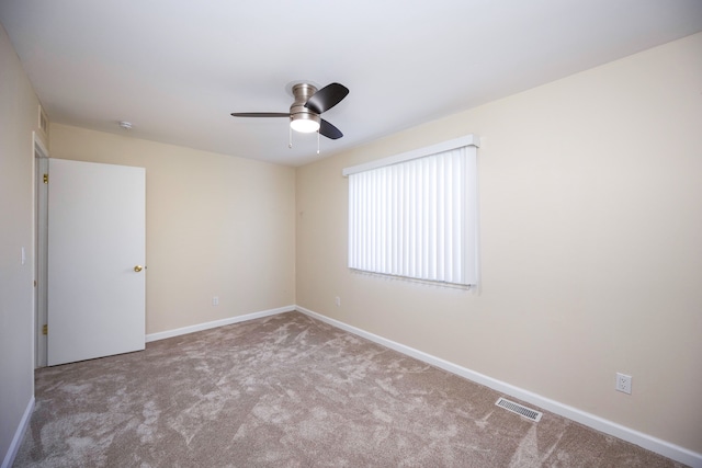 empty room with ceiling fan and light colored carpet