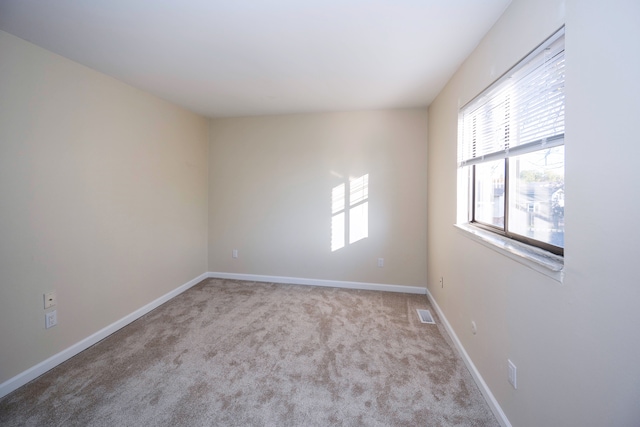 unfurnished room featuring light colored carpet