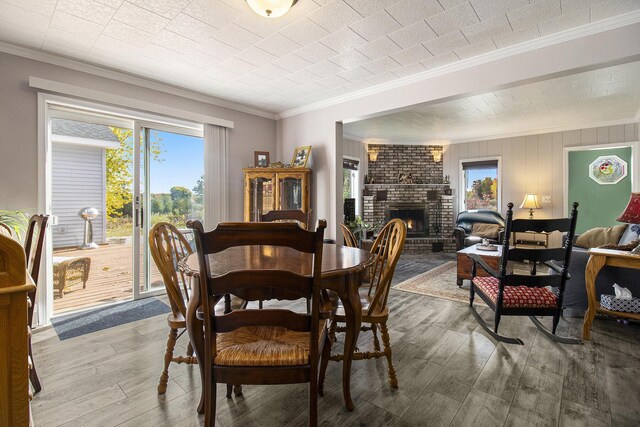 2702 E Hoague Rd, Michigan, MI 49411 - dining space featuring ornamental molding, hardwood / wood-style floors, and a fireplace
