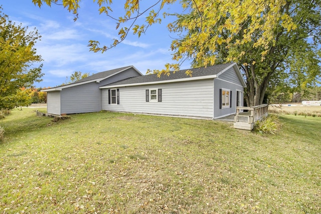 rear view of house featuring a yard