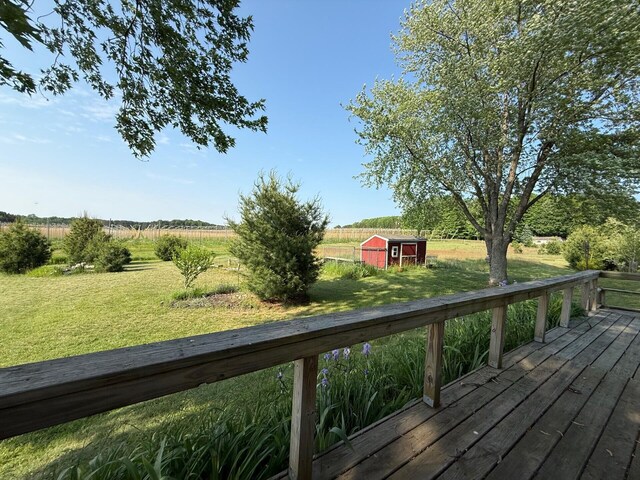 2702 E Hoague Rd, Michigan, MI 49411 - deck featuring a rural view, a yard, and a shed