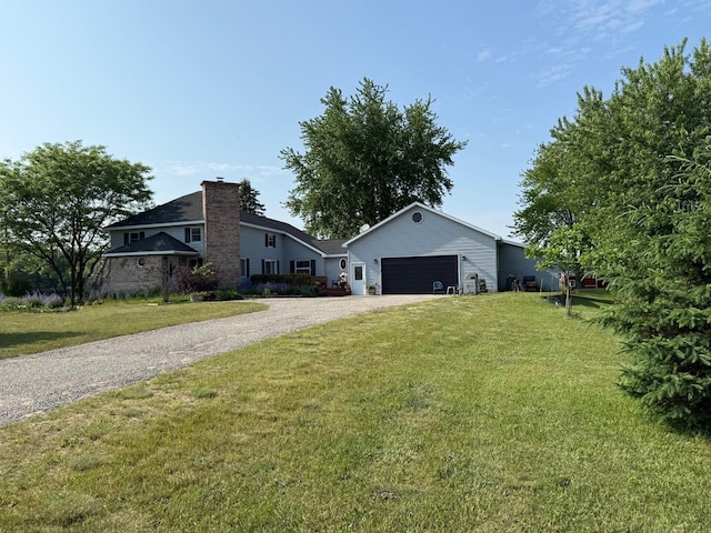 2702 E Hoague Rd, Michigan, MI 49411 - view of front of property with driveway, a garage, a front yard, and a chimney