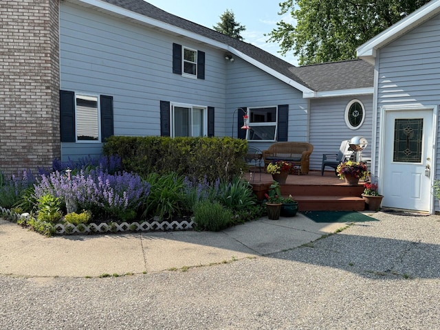 2702 E Hoague Rd, Michigan, MI 49411 - doorway to property featuring a wooden deck and roof with shingles