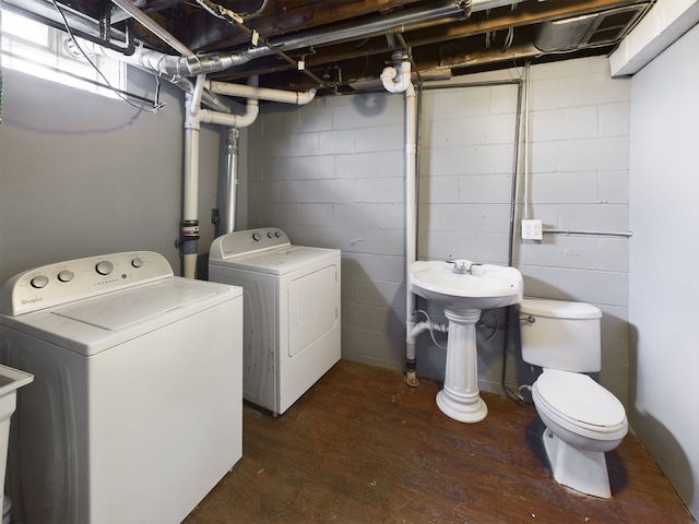 laundry area featuring washer and clothes dryer and dark hardwood / wood-style floors