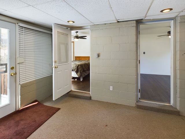 carpeted foyer entrance featuring a paneled ceiling