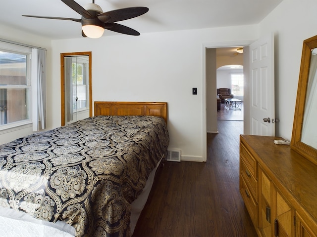 bedroom with ceiling fan and dark hardwood / wood-style floors