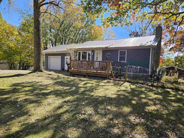 ranch-style home with a front yard, a garage, and a wooden deck