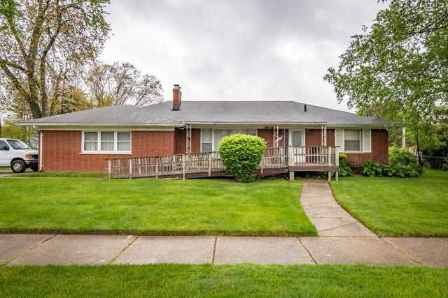 25672 Avondale St, Dearborn Heights, MI 48125 - single story home with a chimney, a front yard, brick siding, and a wooden deck