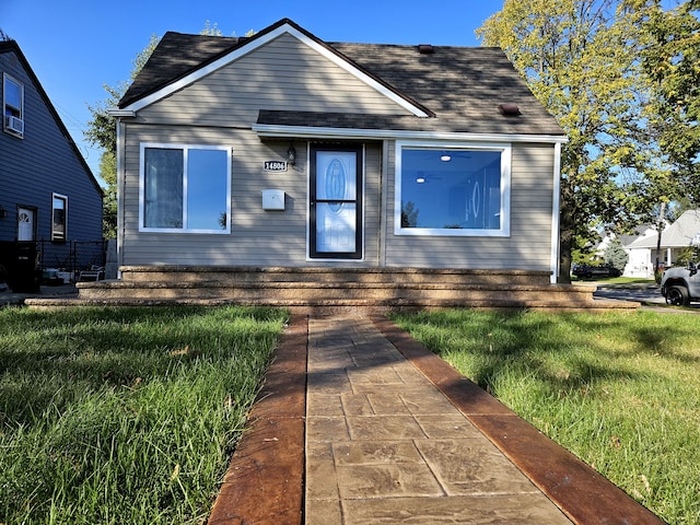 bungalow-style house featuring a front yard