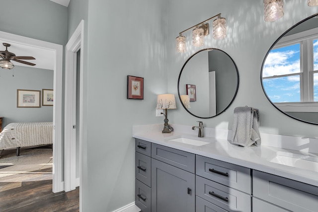 bathroom featuring wood-type flooring, vanity, and ceiling fan